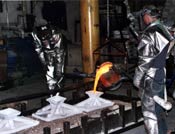 molten bronze being poured into silica molds